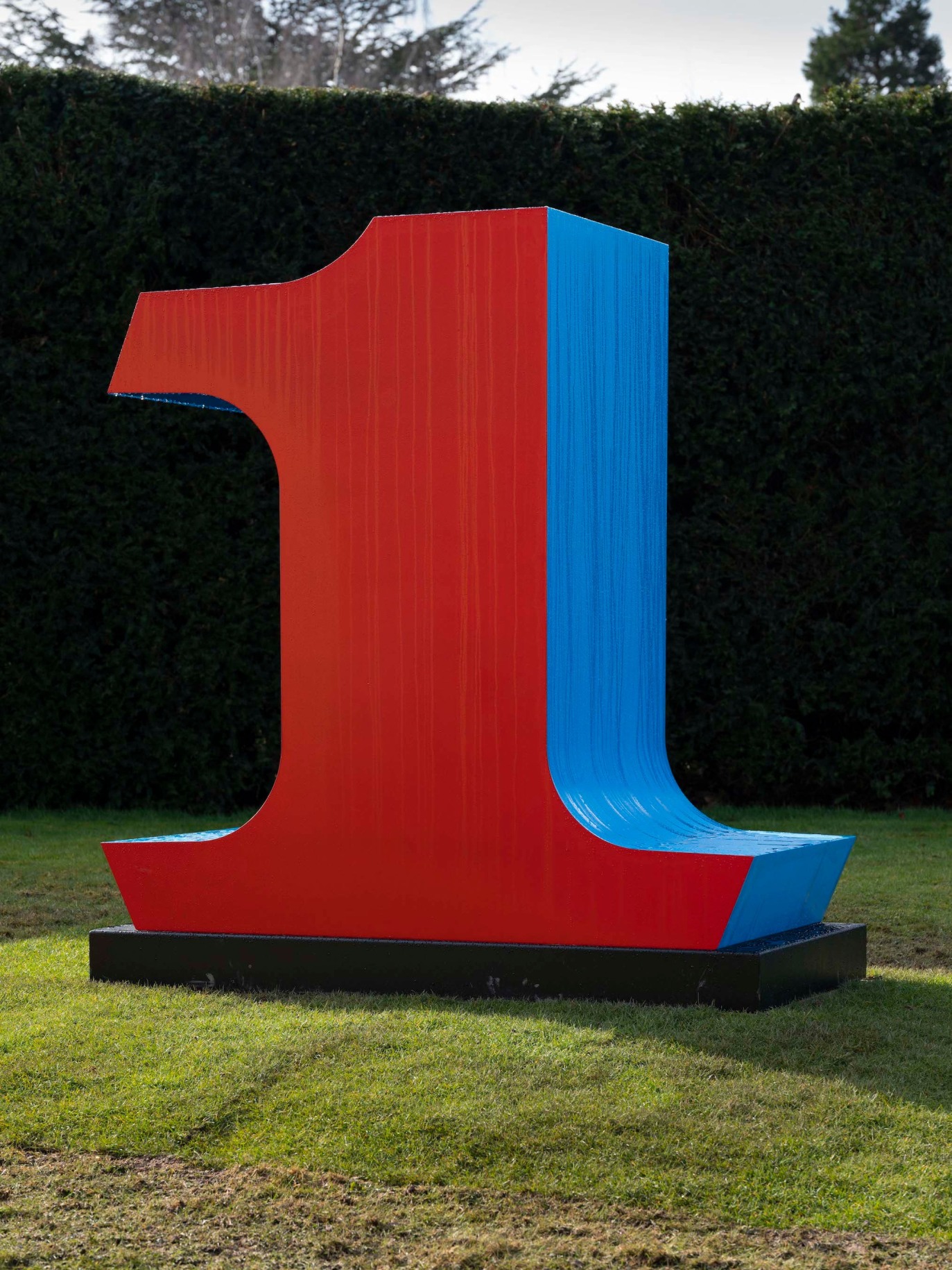 Indiana's red and blue polychrome aluminum sculpture of the number ONE installed at Yorkshire Sculpture Park
