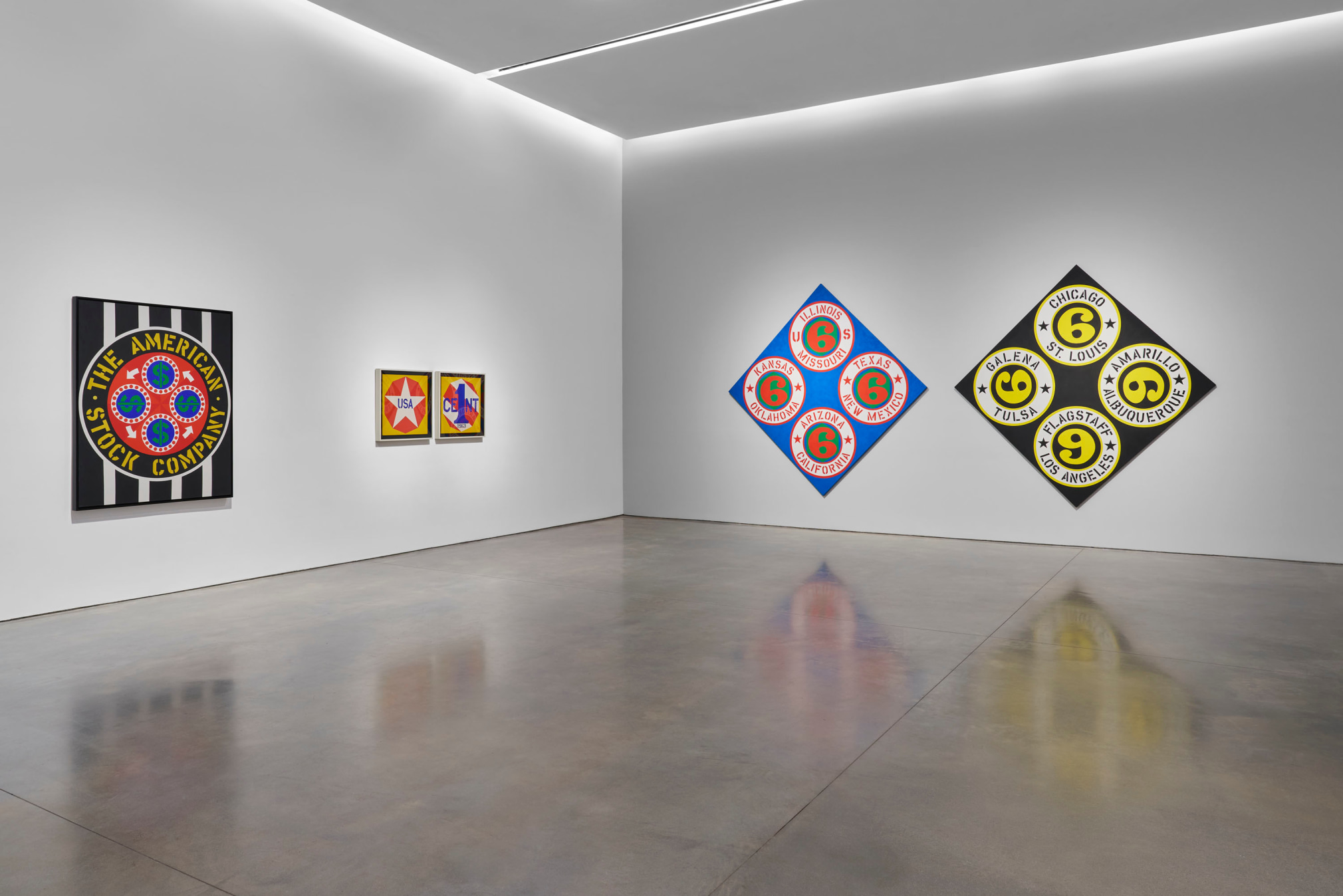 Installation view, Robert Indiana: The American Dream, Pace Gallery, New York, May 9&ndash;August 15, 2025. Left to right, The American Stock Company (1963), New Glory Penny (1963), and&nbsp;US 66 (States)/US 66 (Cities) (2002)