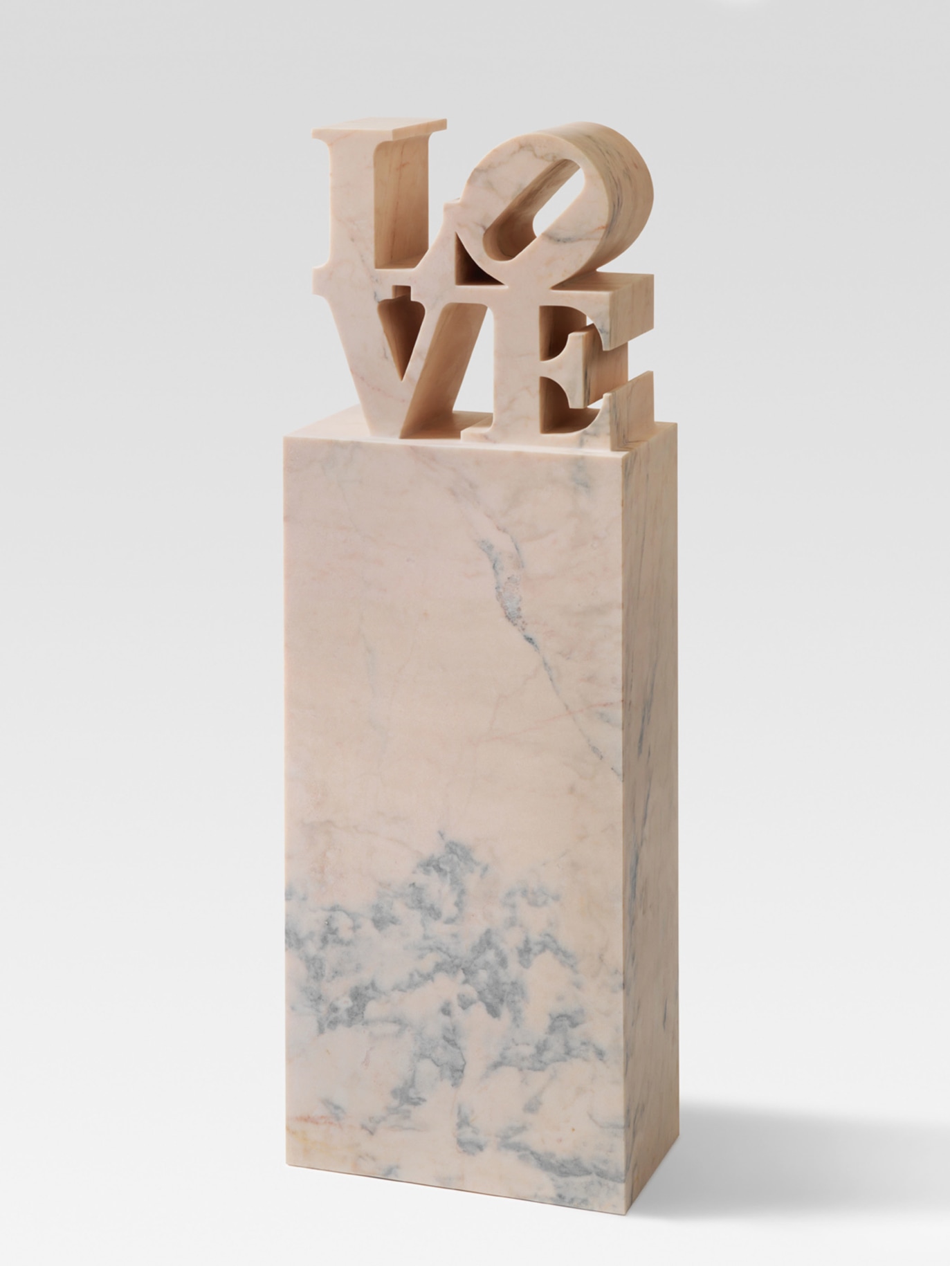LOVE is a 65 15/16 &times; 22 1/8 &times; 12 5/16 inch, including the base, pink marble sculpture with the letters L and a tilted O stacked above the letters V and E, atop a tall rectangular base.