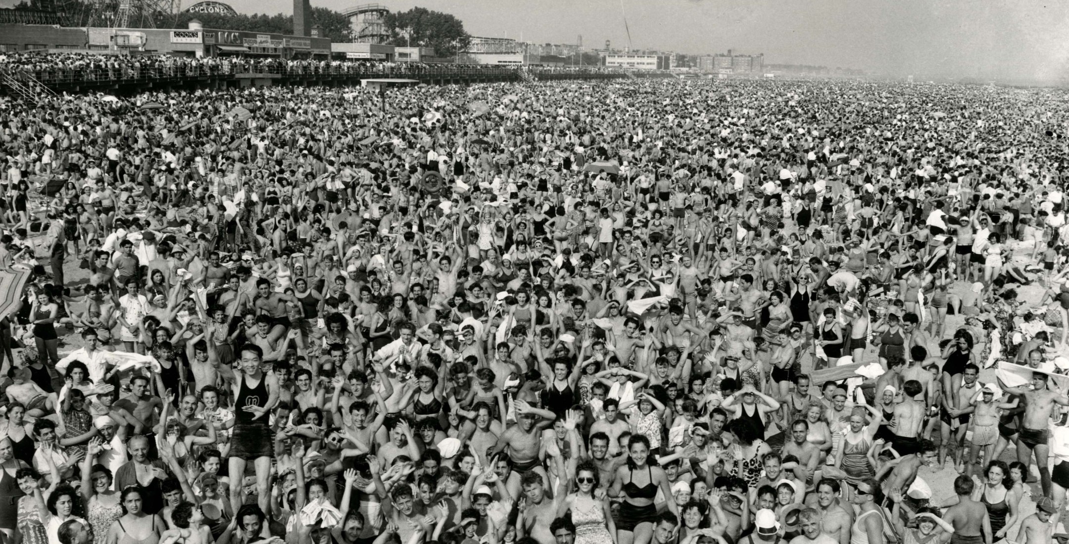 Weegee&mdash;Exposure  | Black and white phtograph of a crowd at Coney Island&mdash;faciing camera&mdash;1946.