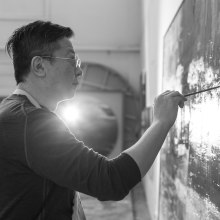Wang Yan Cheng painting in his studio