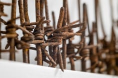 Hold the Line, 2015, reclaimed military barbed wire, painted MDF, 6.3 x 72 x 1.4 in.
