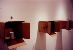 carved cardboard boxed displayed on gallery wall