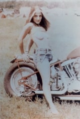 Photo of topless woman on motorcycle