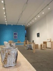 Wooden benches with ceramics, blue wallpaper