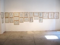 Framed graphite and ink sketches on gallery walls