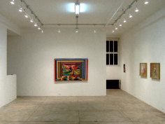 Exhibition view, showing rainbow abstract with smaller framed works