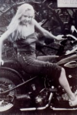 Woman posing on motorcycle, photo