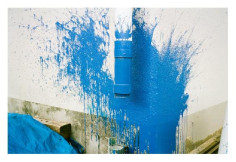 Photo of blue paint splattered on white corner wall