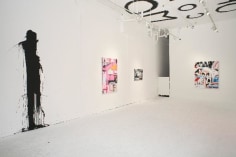 Installation view, with black paint splattered on gallery wall