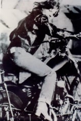 Photo of person in leather jacket on motorcycle