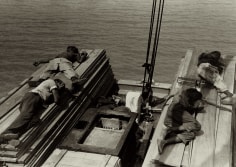 Russell Lee  Untitled (men lying on stacks of wooden planks on boat), c.1937 Gelatin silver print; printed c.1937 9 1/2 x 13 1/2 inches, Howard Greenberg Gallery, 2020