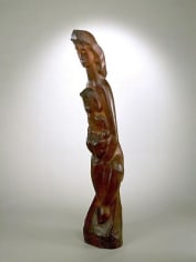 Smooth wooden sculpture of a woman leaning forward. She is looking downward and holds a young child in her arms.