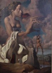 Surrealist painting of a giant, partially nude woman, draped in off-white cloth. She is set against a landscape scene and is poised, kissing kiss pair of red lips positioned in the center-top of the sky behind her. In her left hand, which is exaggeratedly larger than the rest of her giant figure, are the strings that attach to a much smaller nude figure below her &ndash;&ndash; making her appear as though she is a puppeteer controlling her puppet.