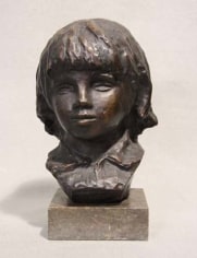 Bronze bust of Coco, the artist's young son, depicted with chin length hair and a collared shirt. The bust sits on a stone base.
