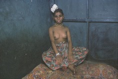 Kanta with flowers in her hair, sitting in the corner of her bed, Bombay, 1978, 12-1/4 x 18-3/4 Dye Transfer Photograph