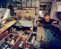Man in his basement with models of North End businesses, including his barbershop, Boston, MA, 2003