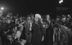 Coretta Scott King holding a candle and leading a march at night to the White House as part of the Moratorium to End the War in Vietnam, 1969.