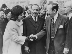 Coretta Scott King shakes hands with New York City Mayor Robert Wagner as Dr. Martin Luther King, Jr. stands between them, 1964.
