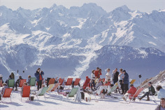 ​Slim Aarons, Lounging In Verbier: Holidaymakers in sun loungers on the slopes at Verbier, Switzerland, February 1964