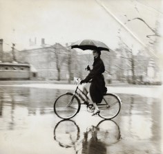 Tom Palumbo, Anne St. Marie on Bike with Umbrella, circa 1956