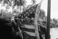 Mary Ellen Mark, Dennis Hopper plays with an American flag, Apocalypse Now, Pagsanjan, Philippines, 1976