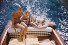 Slim Aarons, Carla Vuccino and Marina Rava sit on the rear of a boat, on the waters off the coast of the island of Capri, Italy, 1958