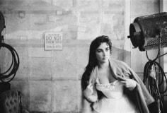 Bob Willoughby, Elizabeth Taylor throws a dressing gown over her costume on the MGM set of “Raintree County”, 1956
