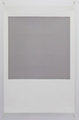 A photograph of a silkscreen on paper. The shape resembles a polaroid (white space on the bottom and a white frame around a central grey space). The grey space in the middle of the work has text in faint gold letters, illegible from a distance.