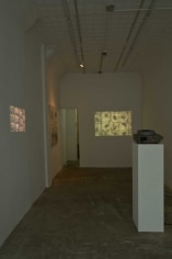 A photograph of the two video projections, one on the back wall and one on the left wall