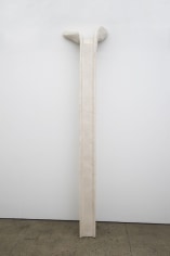 A sculpture leaning against the wall, with the top of the gutter which might be found on a corner of a home being the support on the wall itself. The sculpture is the bone colored (off-white/cream)