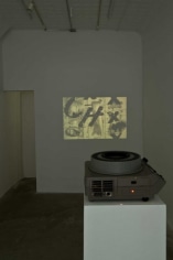 An image of the film with it's projector on a white pedestal