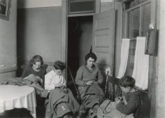 Lewis Hine Grande, Philomena, 218 Thompson Street, N.Y.C., making and finishing coats, earns about $1. a day. Jennie, age 13 and Edmond age 9 work steadly and do not get much chance for recreation. Taken by Hiram Myers, Photo, Publicity Dept., N.Y.C. Location: New York, New York (State), 1922