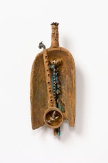 This is an image of a mixed media artwork made by John Outterbridge in 2002 titled: Wooden Horn with Rags.