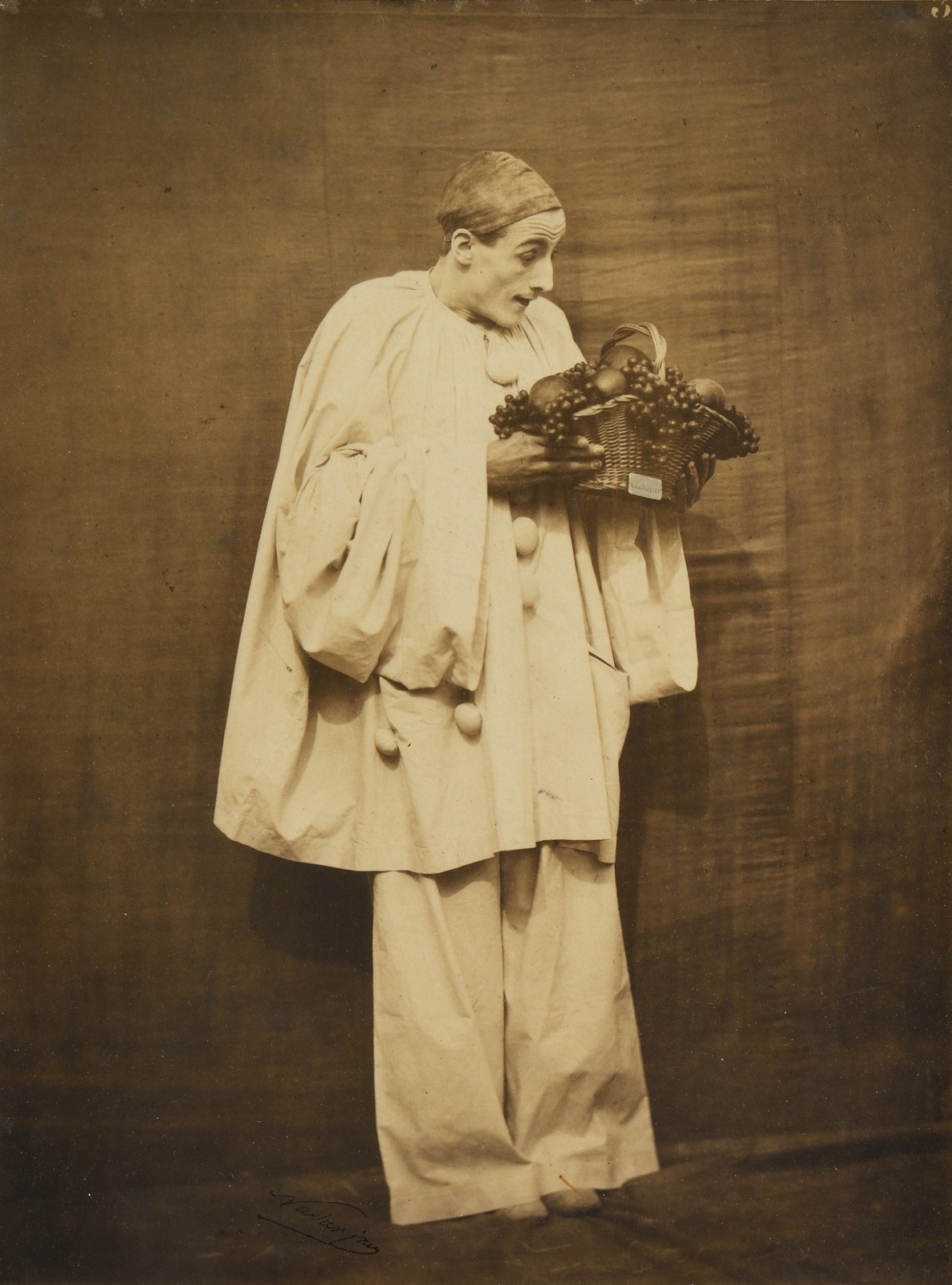 NADAR (Gaspard-F&eacute;lix Tournachon) and Adrien TOURNACHON (French, 1820-1910 and 1825-1903) Pierrot with fruit, 1854-1855 Gelatin coated salt print (vernis-cuir) 28.0 x 20.9 cm