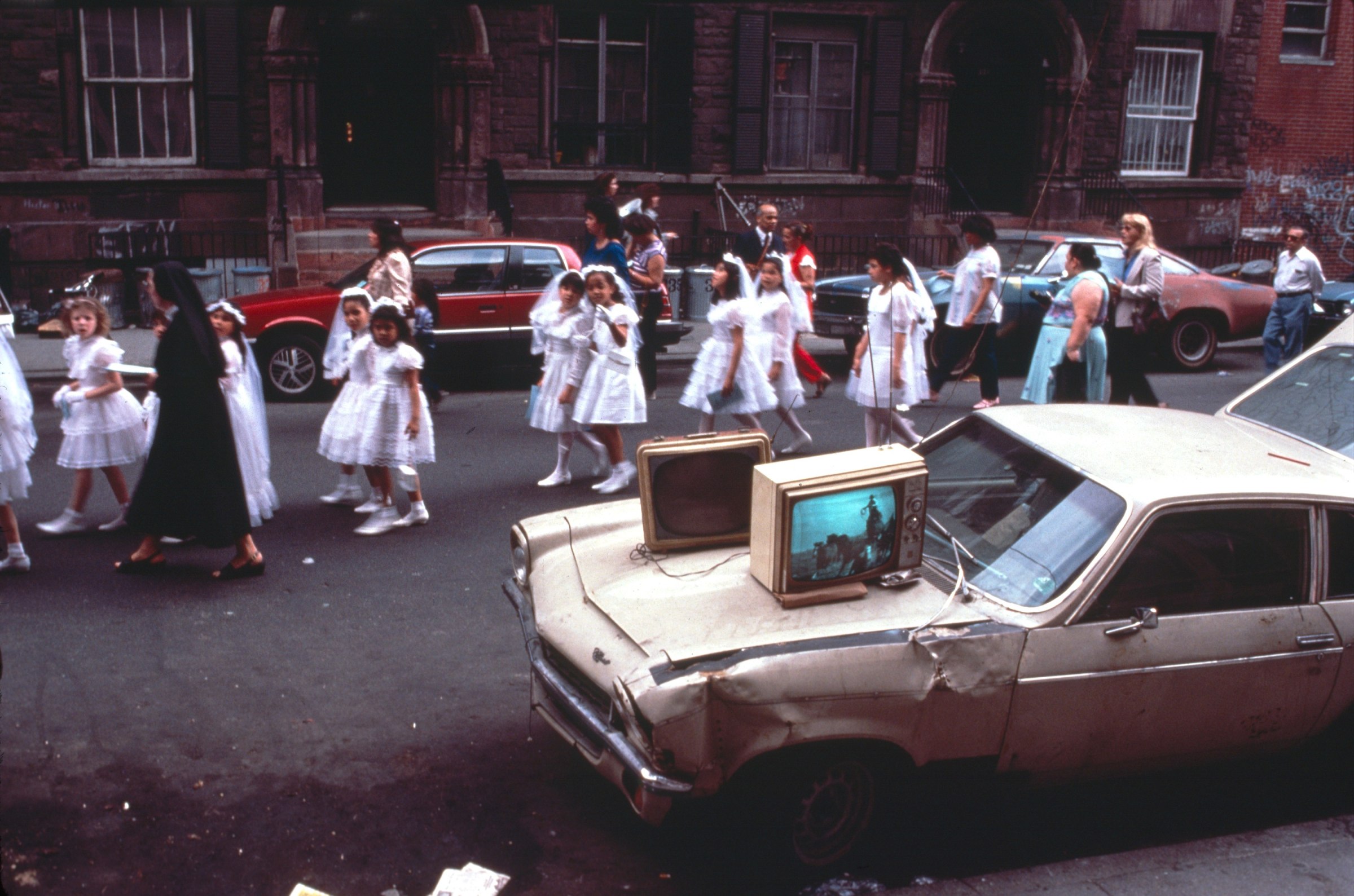 Young girls walking down street by Arlene Gottfried