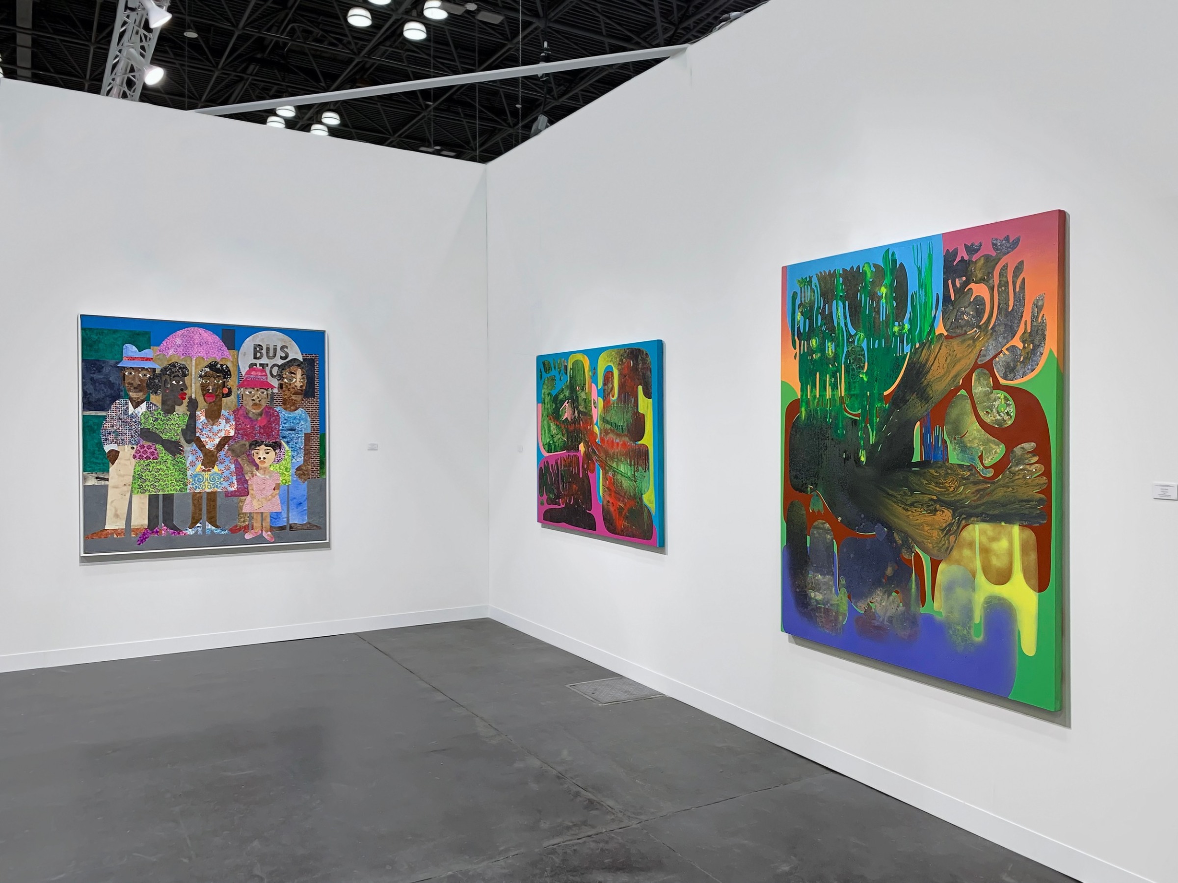 Installation view with Evita Tezeno collage painting on the back wall, Vian Sora painings on the right wall.