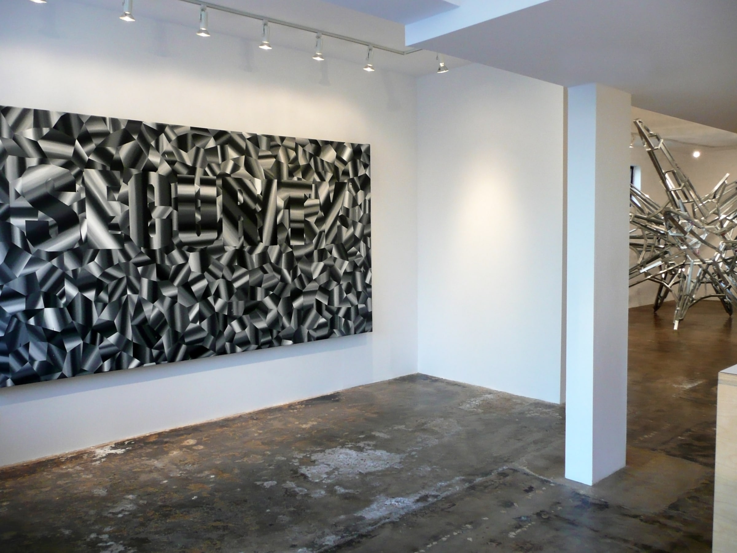 Installation View of Daniel Ruanova's DEFEND: SECURITY | Constructs of a People Fearing Society.