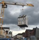 Why Is This House Dangling From the Art Of a Crane