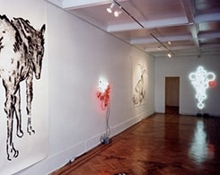 Large animal painting, neon signs on gallery wall