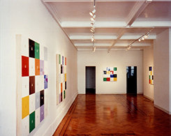 Install view of colorful checkered paintings
