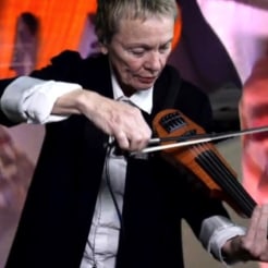 Laurie Anderson performing violin during her Norton Lecture
