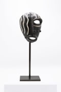 Jaque Sagan's ceramic mask, full front view with metal stand