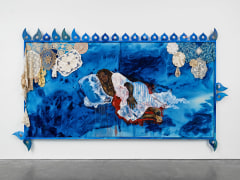 A diptych on canvas showing a relaxed, sleeping woman, depicted in a wash of blue. The painting has lace doilies hanging off the top left and right corners of the painting. The painting's frame is bright blue and has ornamental wooden fretwork attached to the top, bottom left and right corners, and right side of the frame.