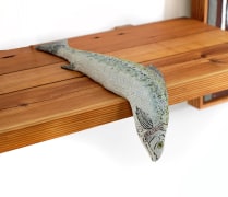 Zachary Armstrong sculpture of fish, resting on wooden shelf