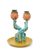 Lola Montes ceramic candelabra with yellow base, teal stems, and two orange artichoke-shaped tops