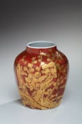 Red-glazed faceted tsubo (vessel) with short raised neck and plum tree and blossoms design in gold overglaze, ca. 1975