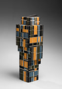 Standing sculpture in a shape of a tall, tiered cubist, building with rectangular decorations, 2019
