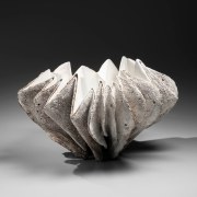 Broad, tightly pleated large shell-shaped vessel with white interior and rough exterior, 2015