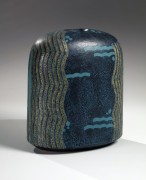Deep ocean blue ovoid vessel with rounded shoulders decorated with wave patterning, ca. 1990